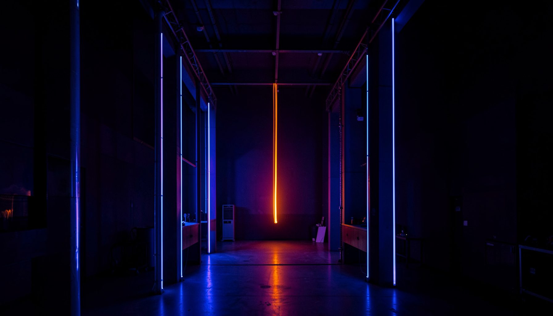 Abstract light trails and amplifier stacks in a darkened venue, electric blue and violet hues